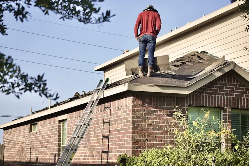 Professional roofer working on a residential roof in Olive